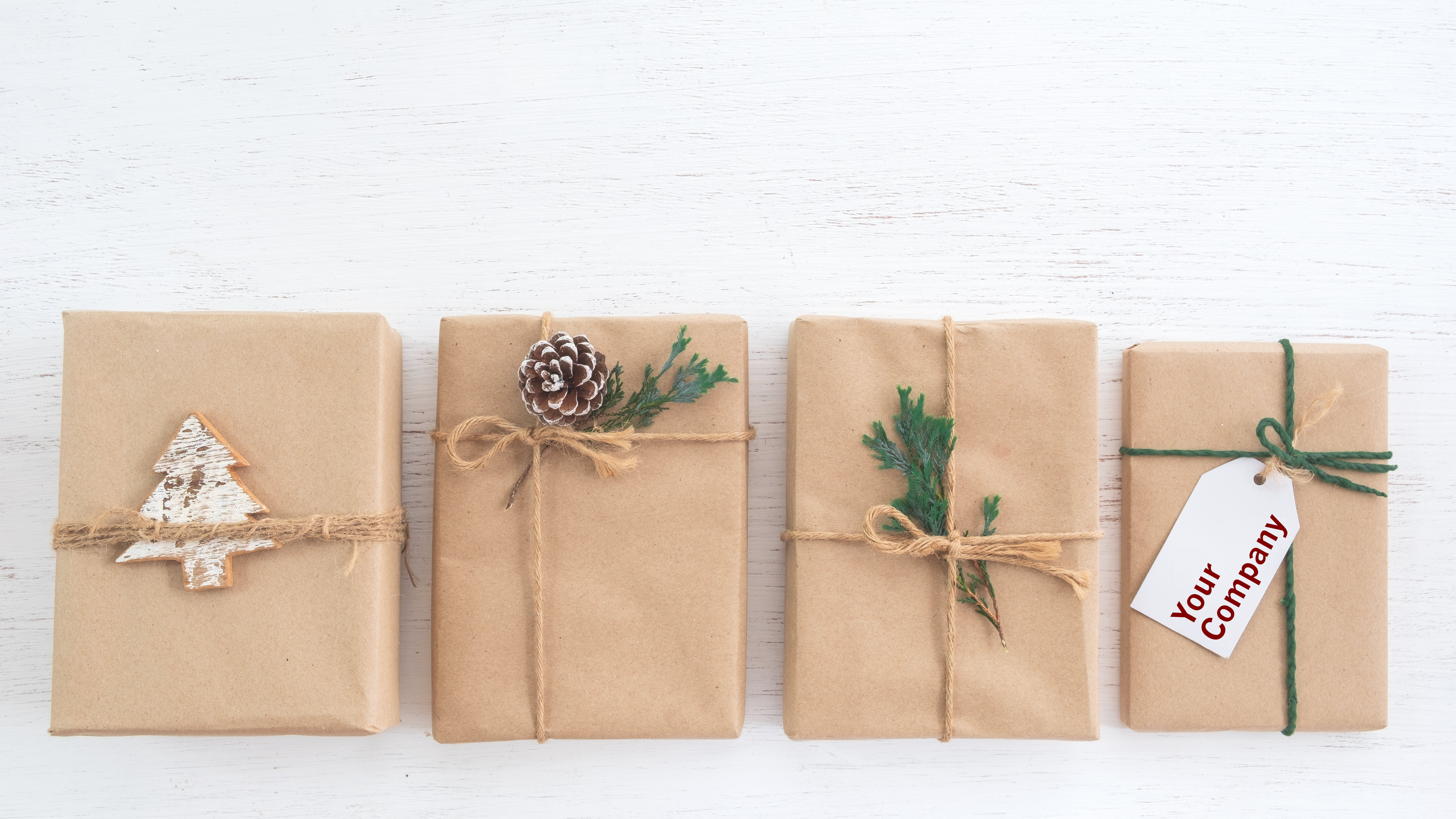 Four wrapped holiday gifts, one with a gift tag that says Your Company