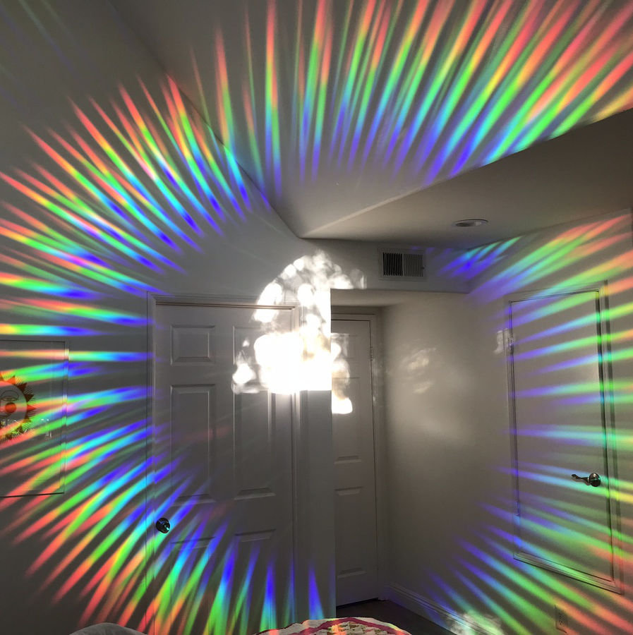 Customer product photo of rainbow suncatcher sticker casting rainbows on wall by Clockwise (Jon Schafer)